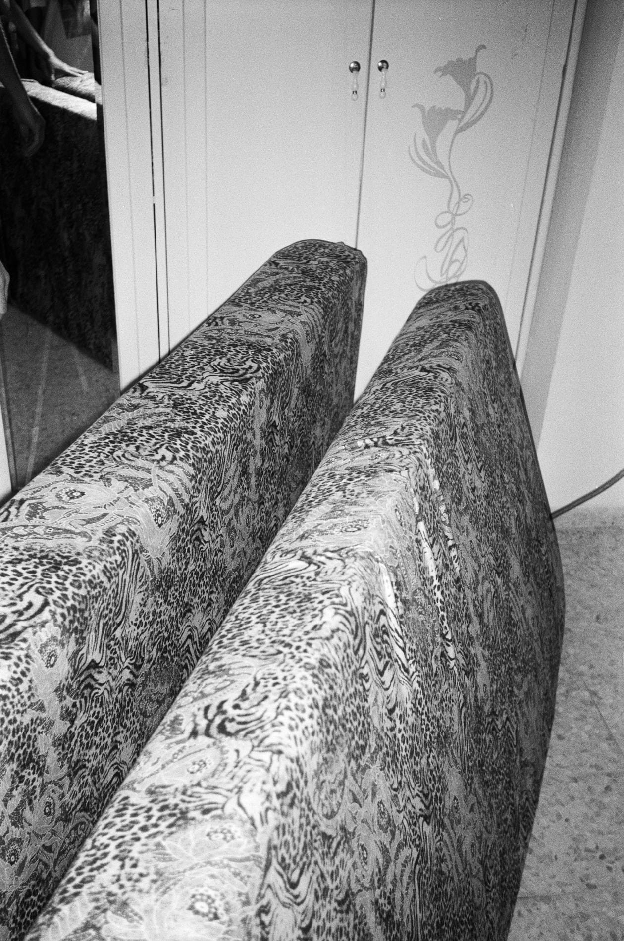 Textured sofa against a cabinet, black and white