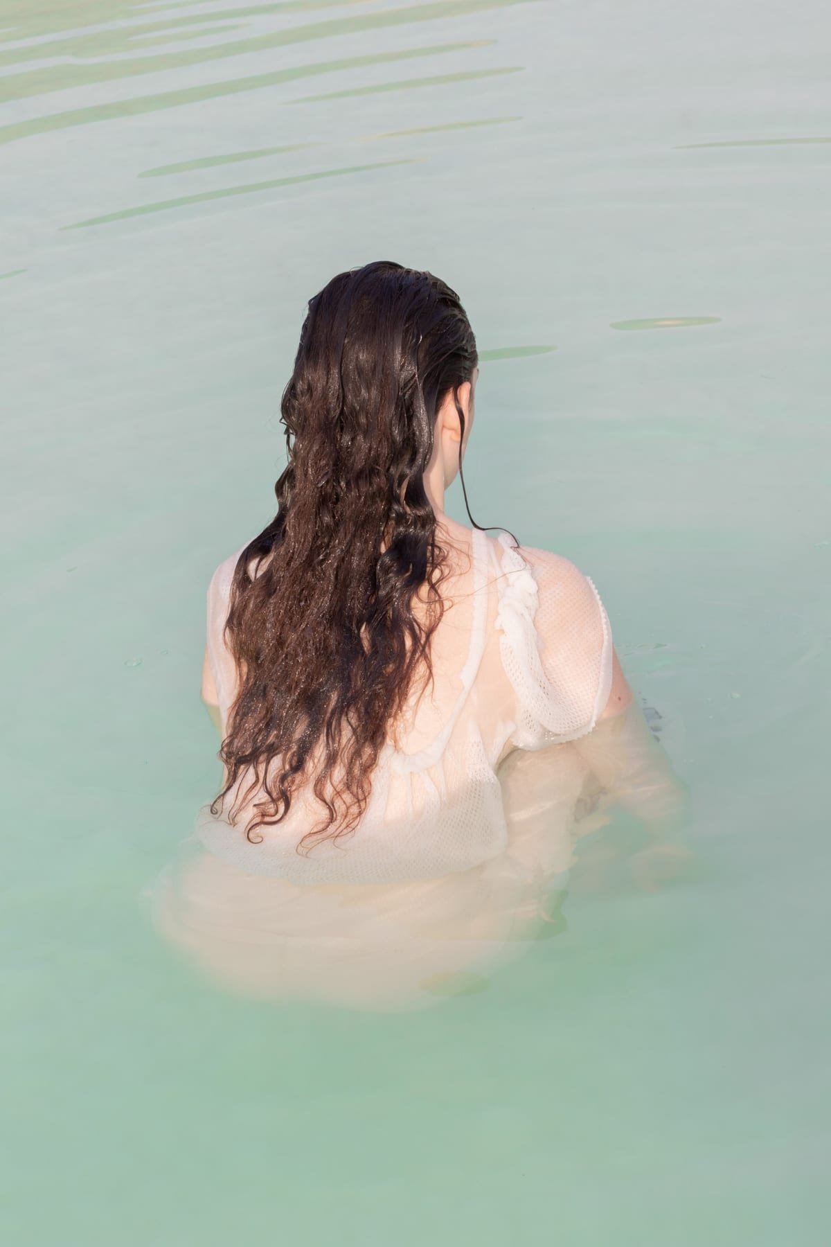 Figure wading into water